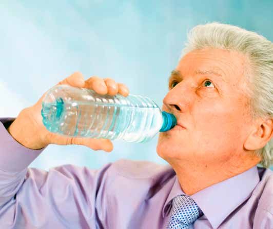 A man drinking a glass of water